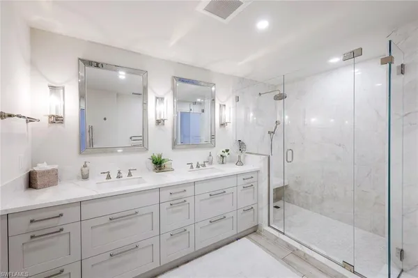 a bedroom with two beds and large window