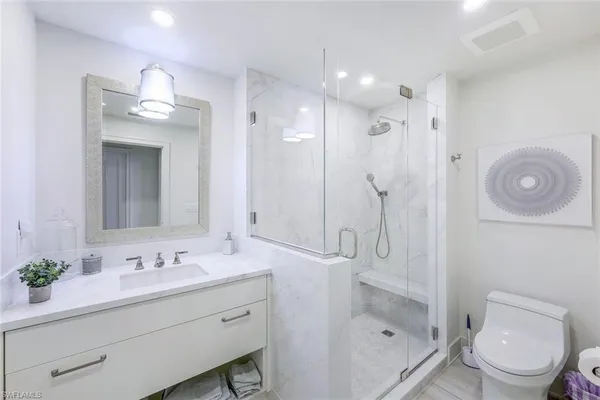 a bathroom with a shower tub double sink and mirror