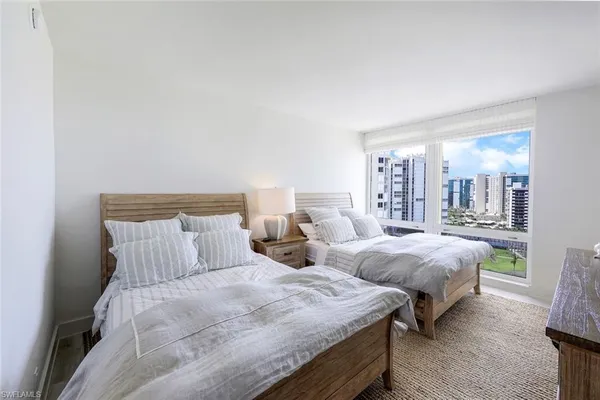 a bed room with a bed a tv and a window