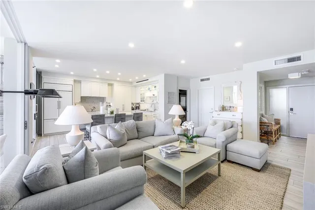 a living room with furniture kitchen and a table