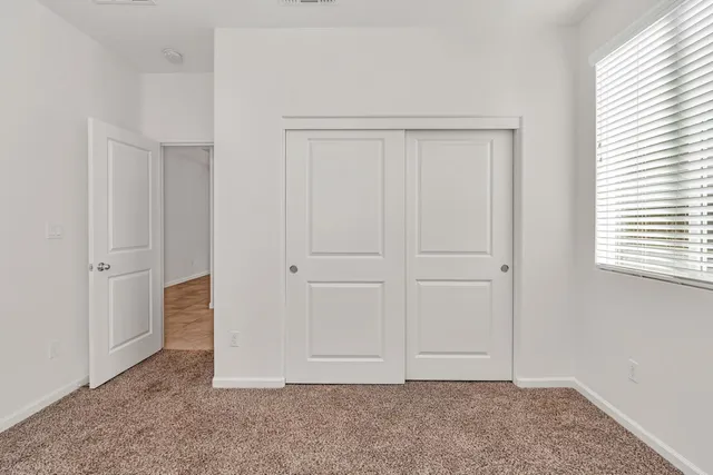 an empty room with closet area
