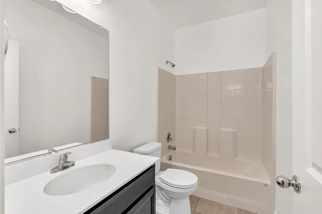 a bathroom with a sink mirror toilet and bathtub