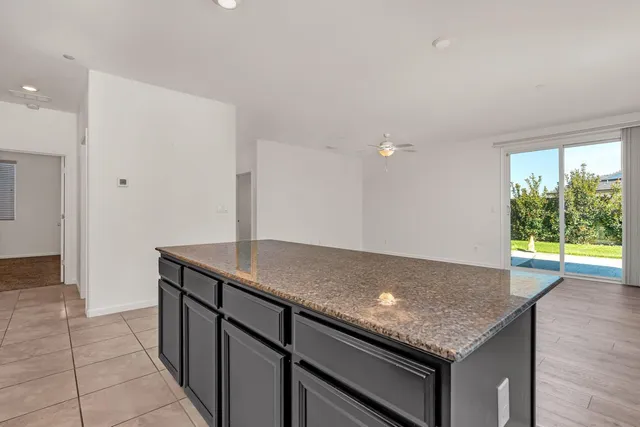 a view of kitchen with stainless steel appliances wooden floor large window and wooden floor