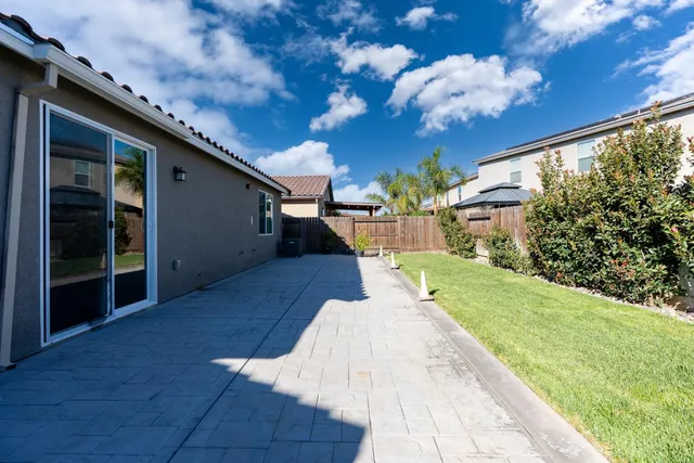 a view of a backyard with potted plants and a fountain