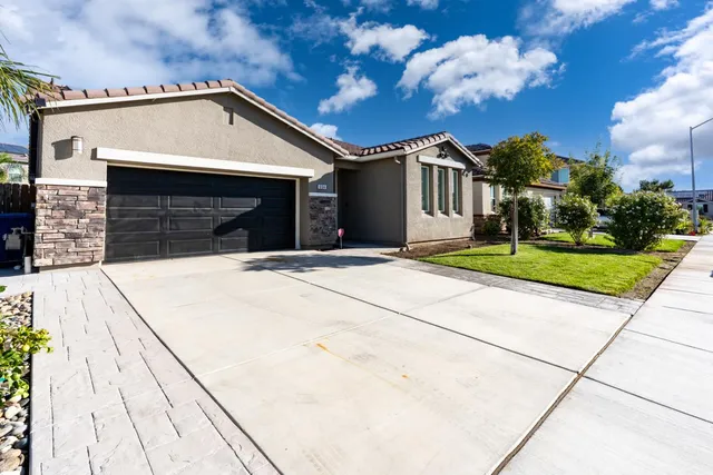 a front view of a house with a garage