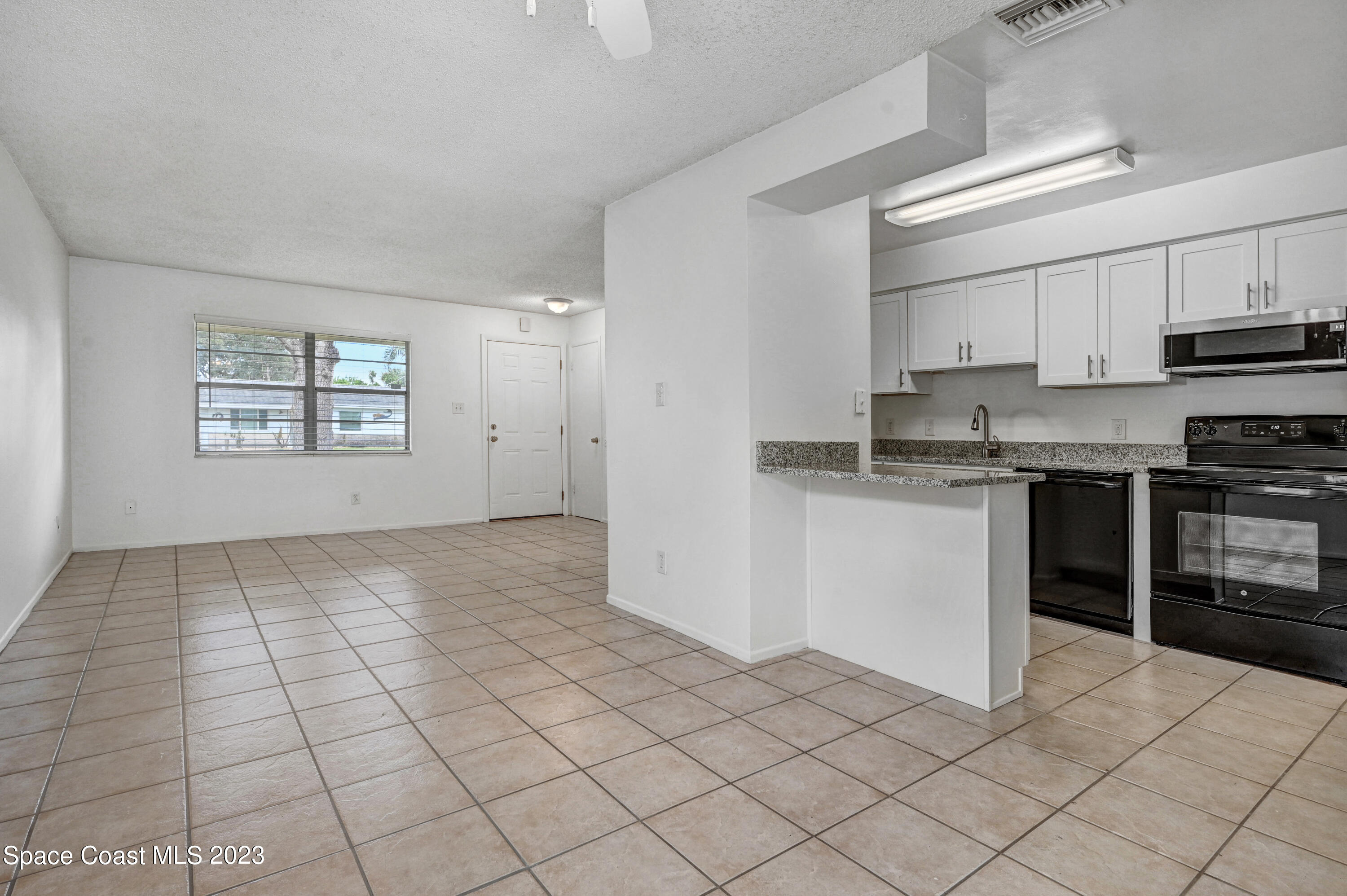 2781 Hereford Road Melbourne, FL 32935 - Photo 11 of 33 a view of kitchen with granite countertop cabinets and window
