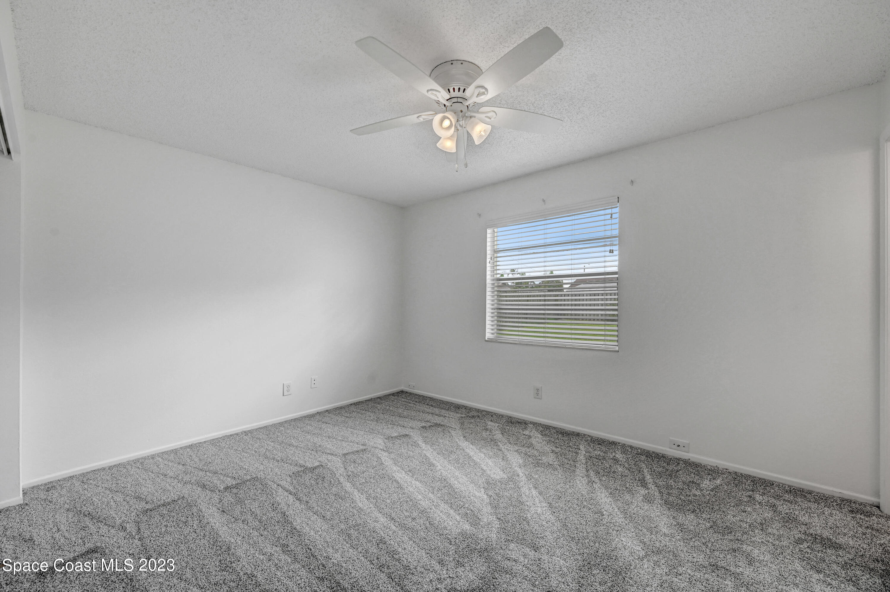 2781 Hereford Road Melbourne, FL 32935 - Photo 19 of 33 a view of an empty room with a chandelier fan