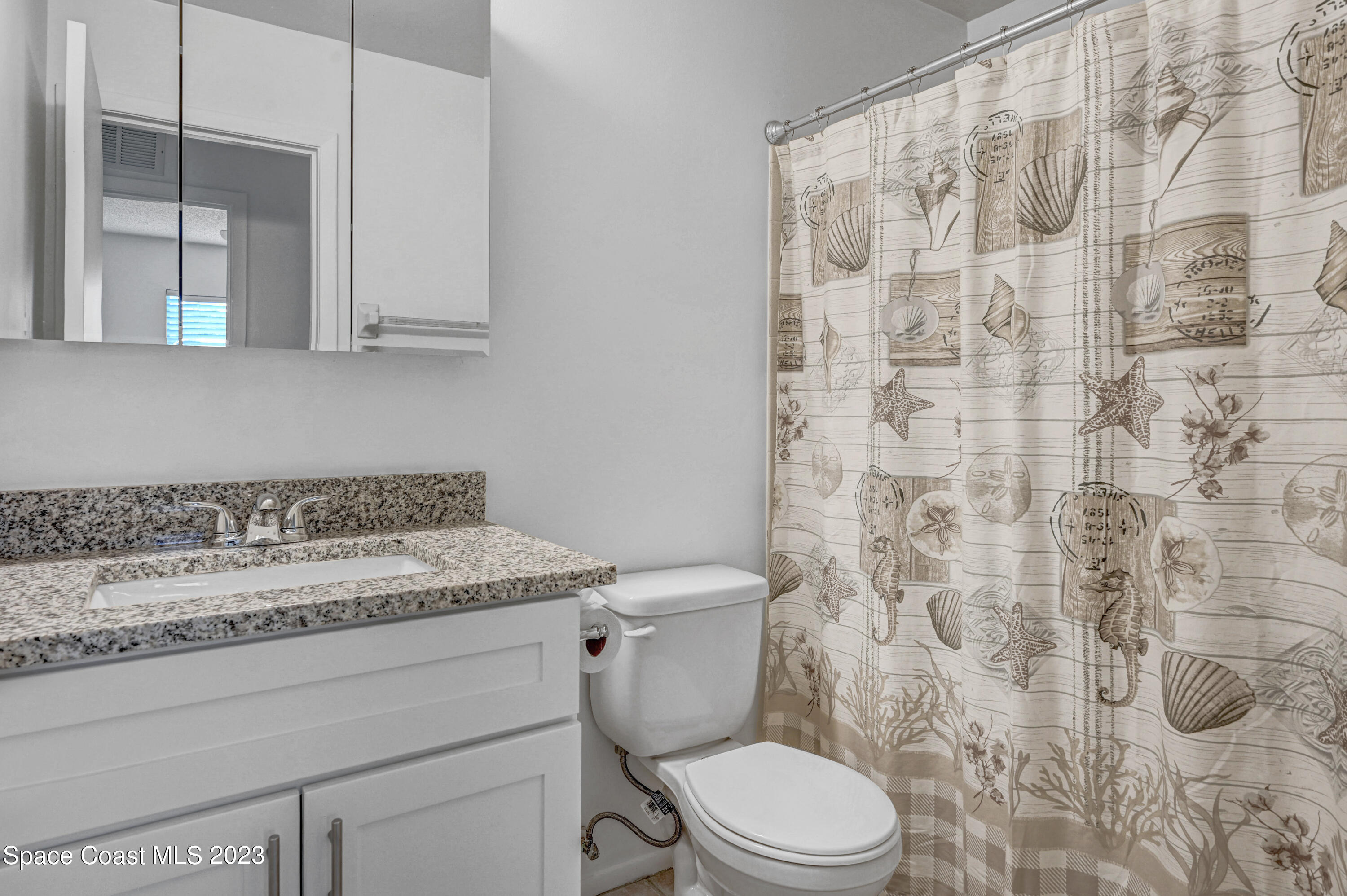 2781 Hereford Road Melbourne, FL 32935 - Photo 20 of 33 a bathroom with a granite countertop toilet and a sink