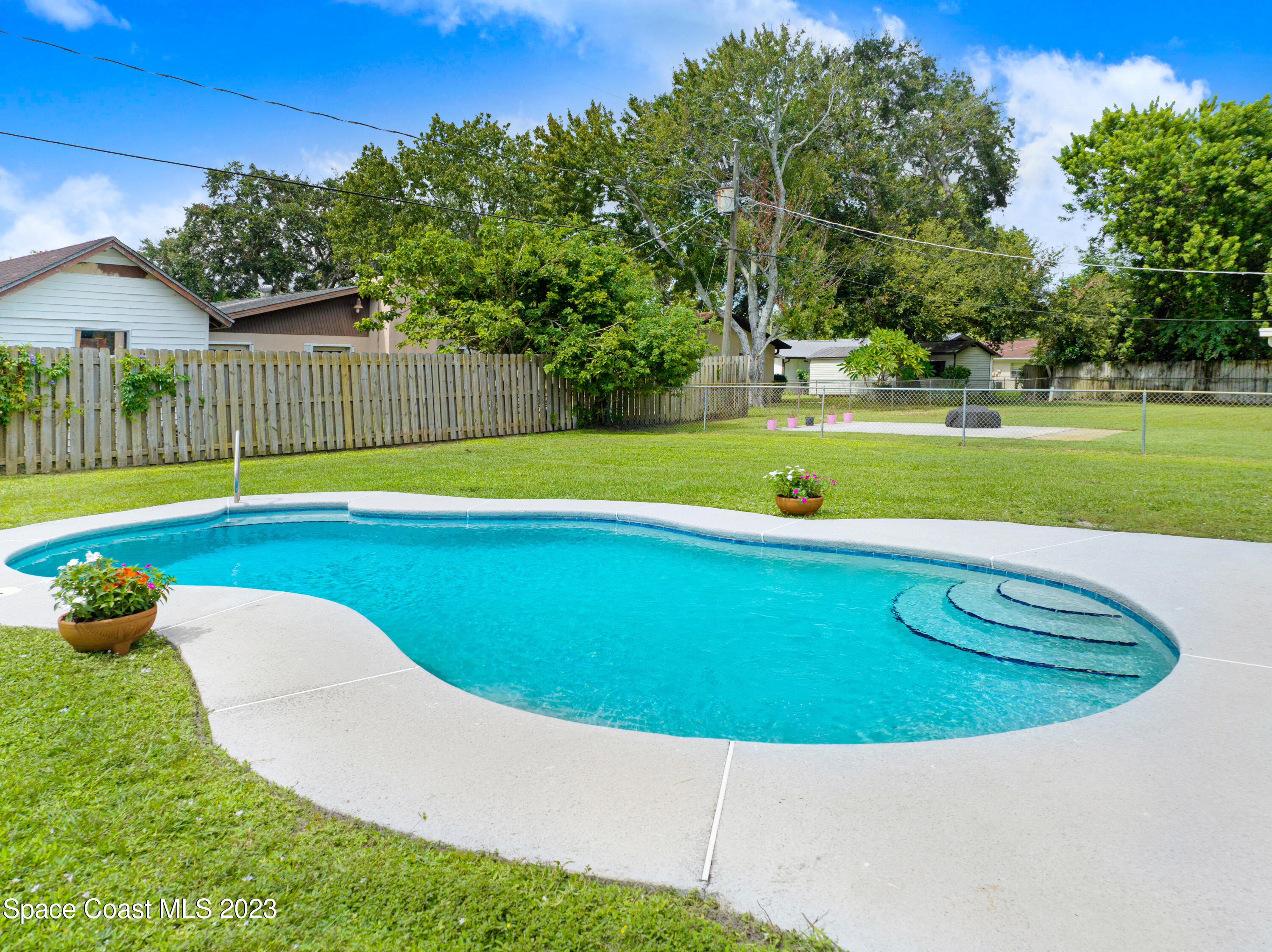 2781 Hereford Road Melbourne, FL 32935 - Photo 2 of 33 a view of a swimming pool with a garden