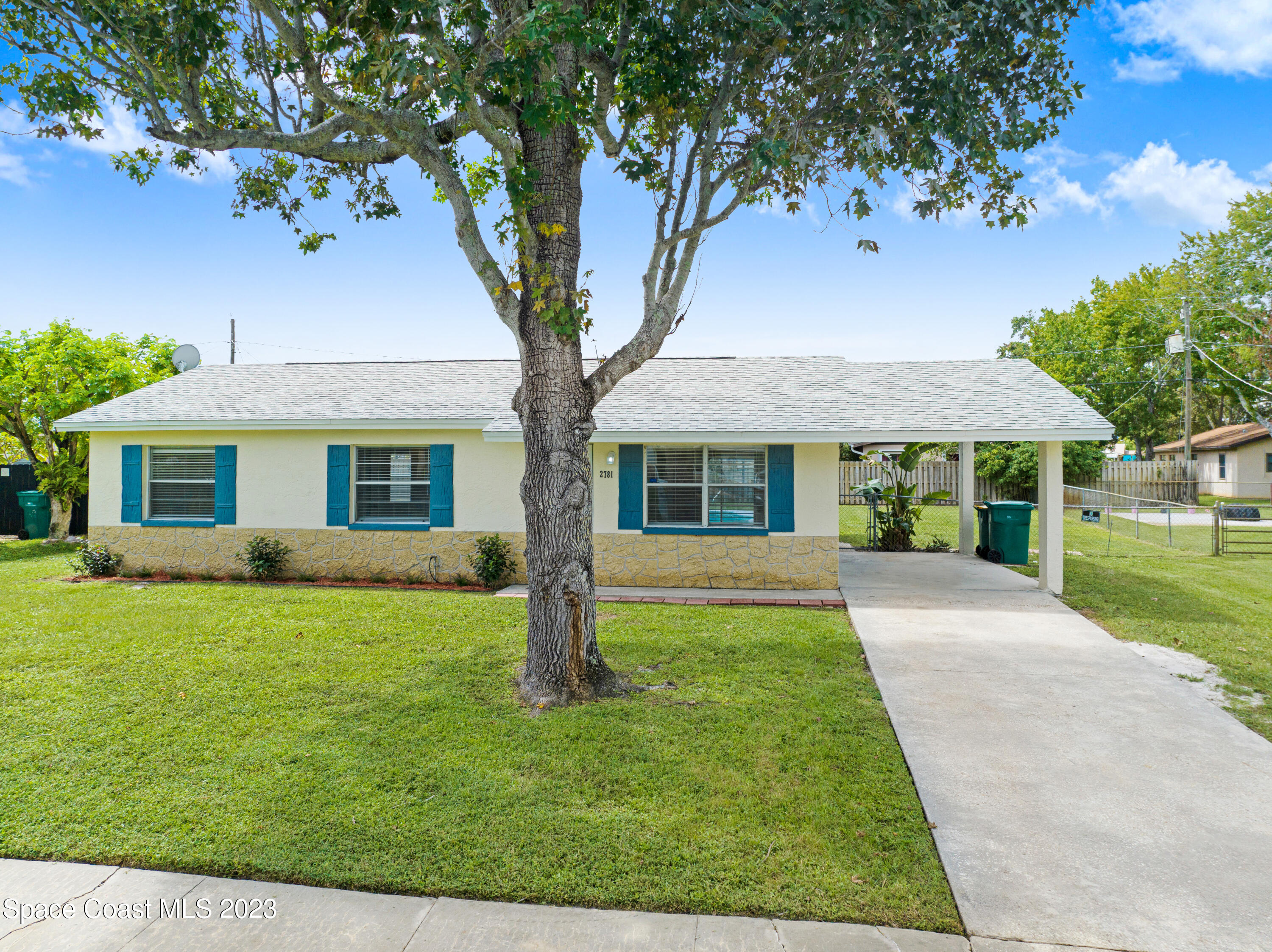2781 Hereford Road Melbourne, FL 32935 - Photo 26 of 33 a front view of a house with a yard