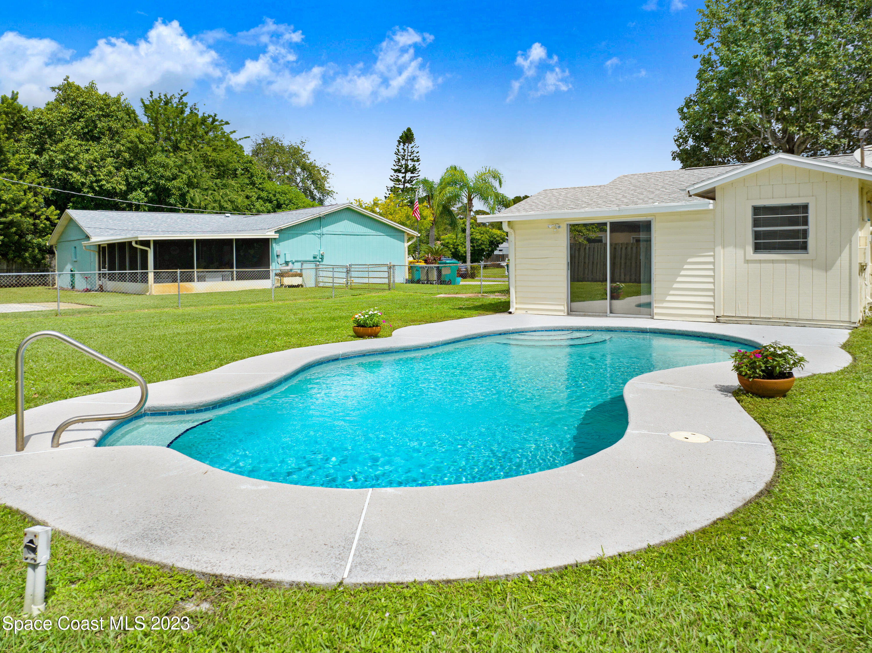 2781 Hereford Road Melbourne, FL 32935 - Photo 33 of 33 a view of a house with a swimming pool and a yard