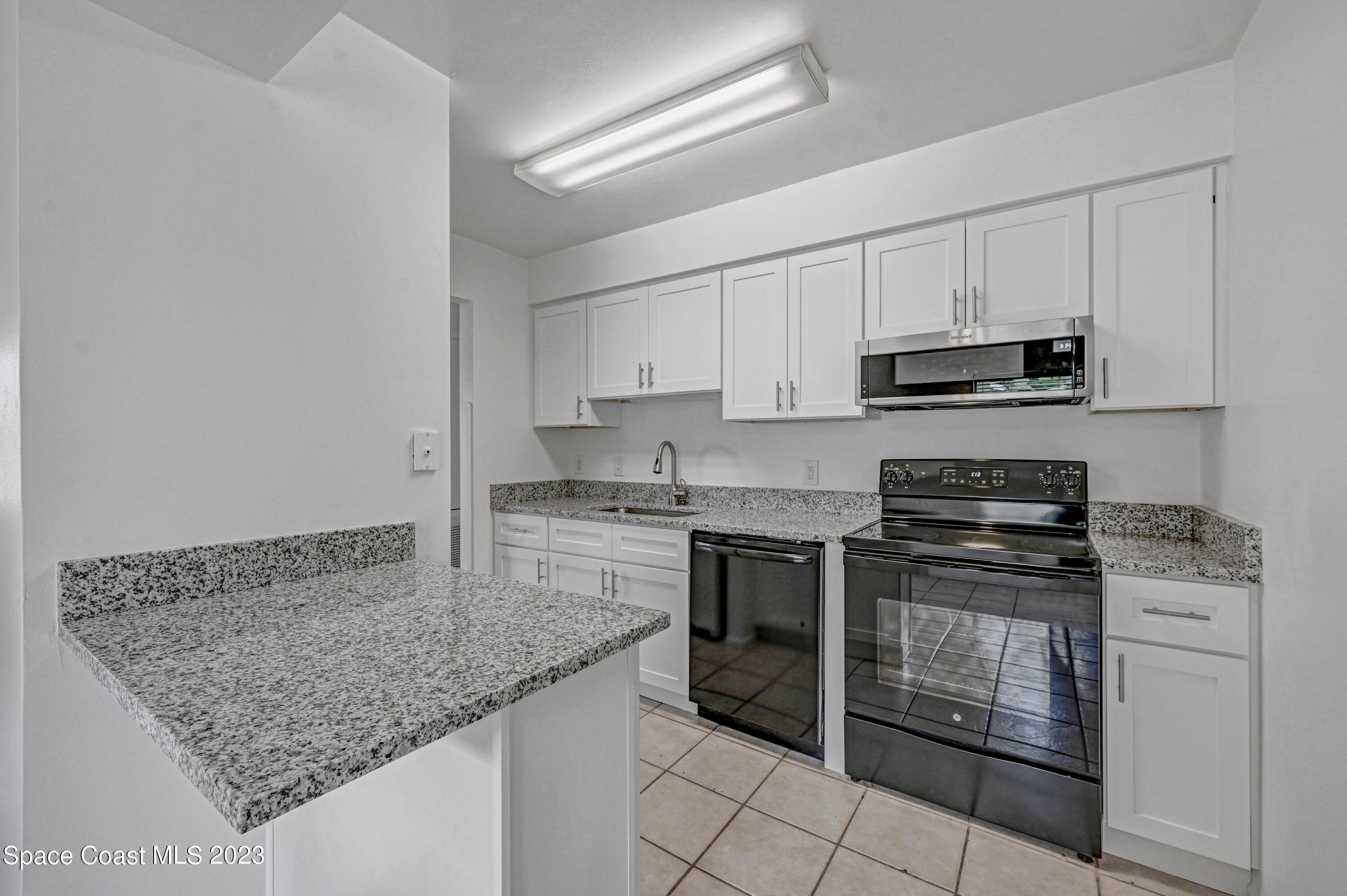 2781 Hereford Road Melbourne, FL 32935 - Photo 4 of 33 a kitchen with stainless steel appliances granite countertop a stove sink and cabinets