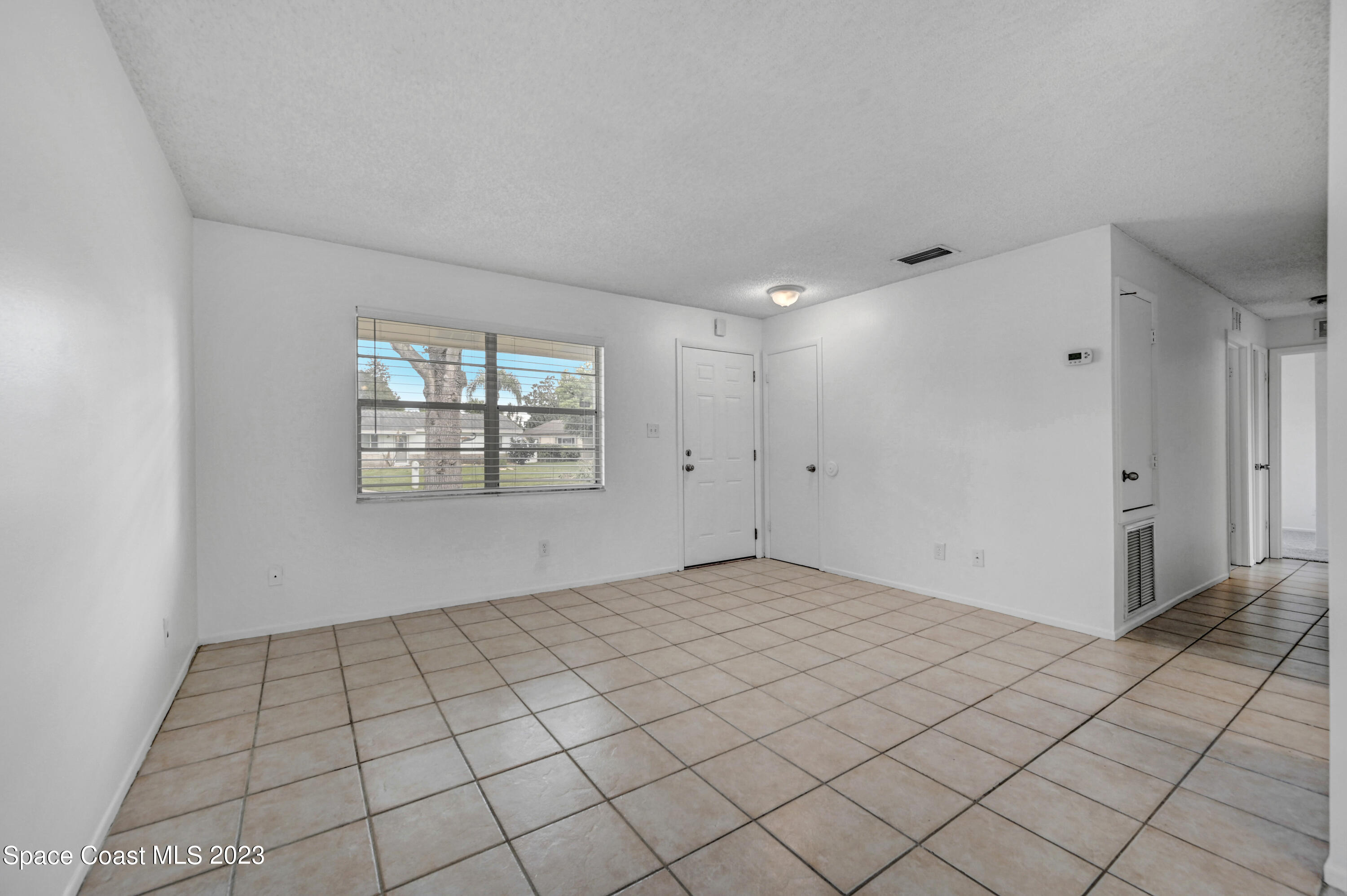 2781 Hereford Road Melbourne, FL 32935 - Photo 6 of 33 a view of an empty room and window