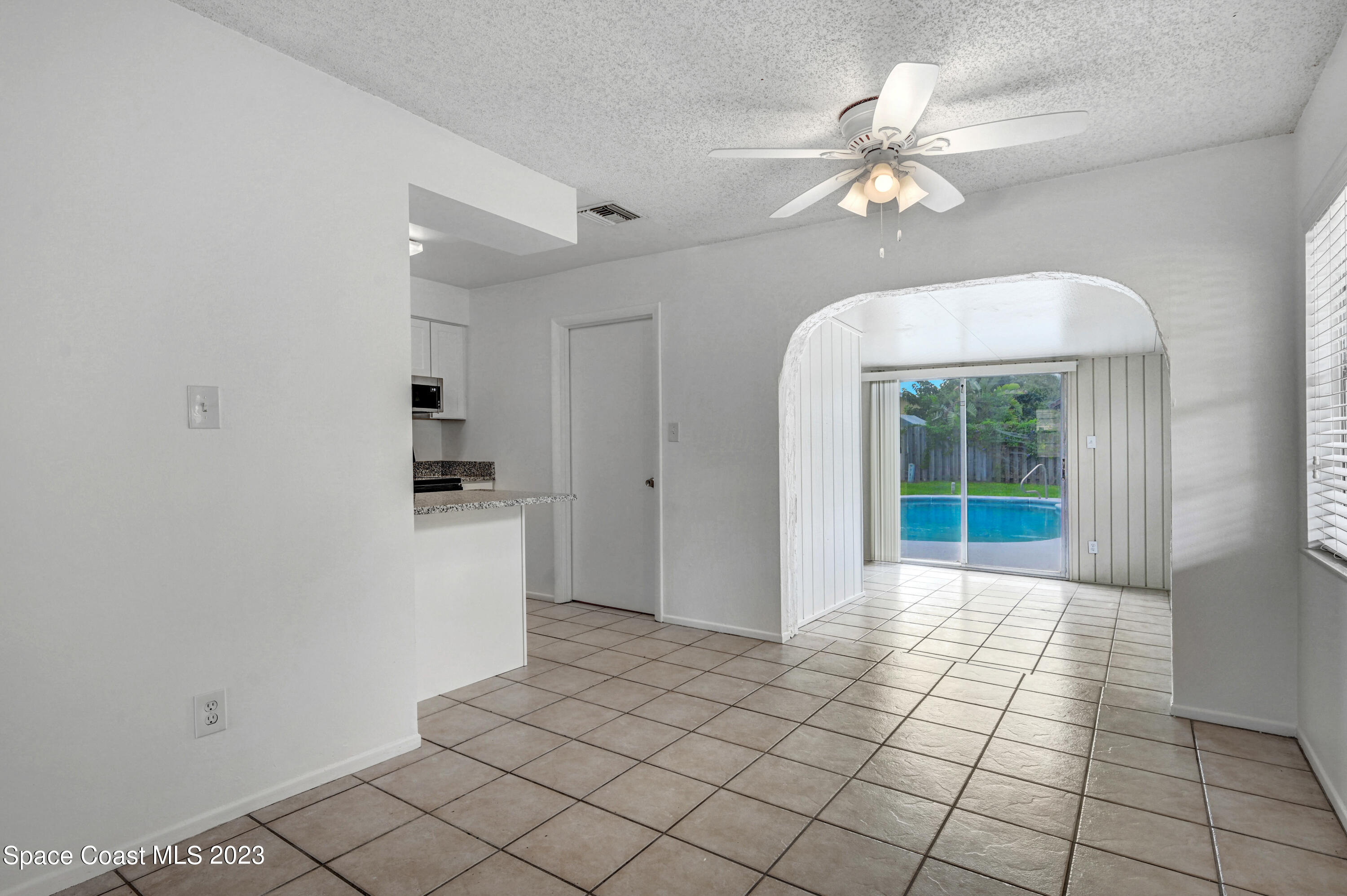 2781 Hereford Road Melbourne, FL 32935 - Photo 9 of 33 a view of a hallway with wooden floor and a chandelier