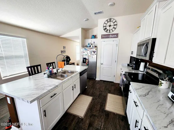a kitchen with a sink appliances and a counter top space