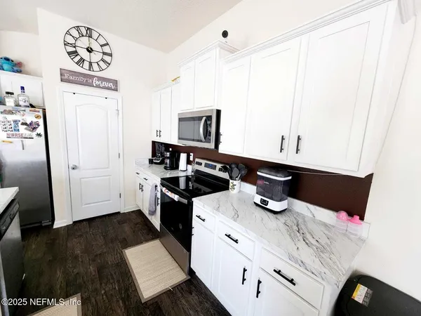 a kitchen with a sink a stove and cabinets
