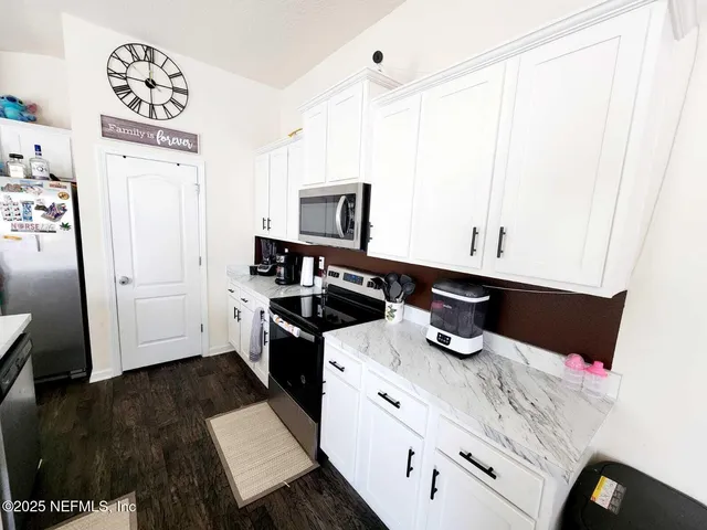 a kitchen with a sink a stove and cabinets