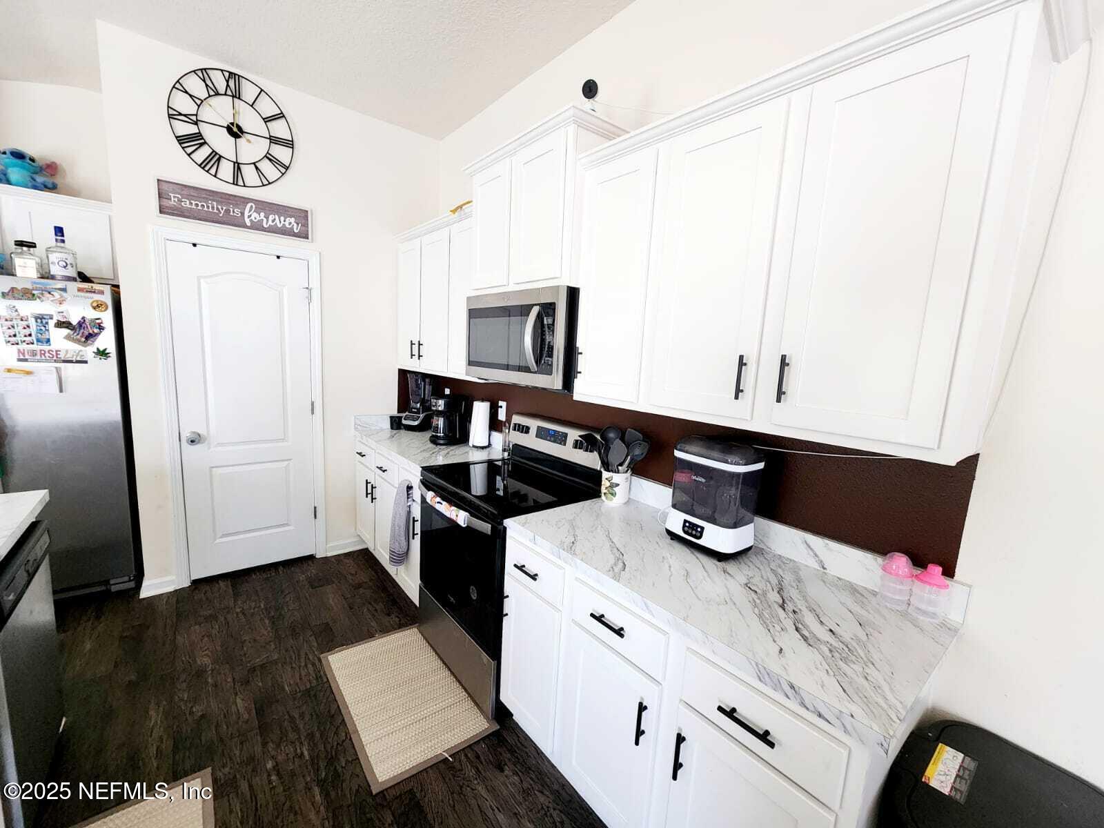 2432 Falling Star Ln Green Cove Springs Green Cove Springs, FL 32043 - Photo 15 of 24 a kitchen with a sink a stove and cabinets