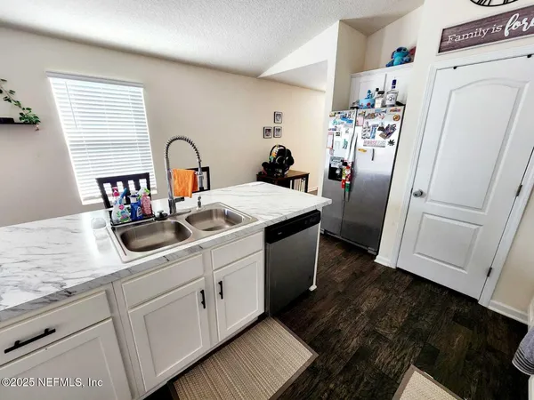 a kitchen with refrigerator and cabinets