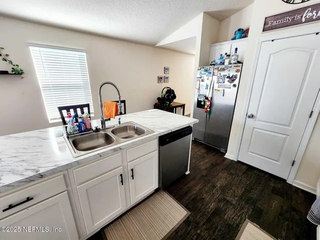 a kitchen with refrigerator and cabinets