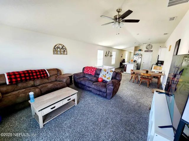 a living room with furniture and a rug