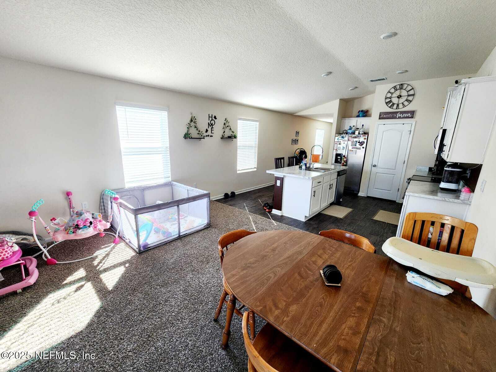 2432 Falling Star Ln Green Cove Springs Green Cove Springs, FL 32043 - Photo 20 of 24 a living room with furniture and a flat screen tv