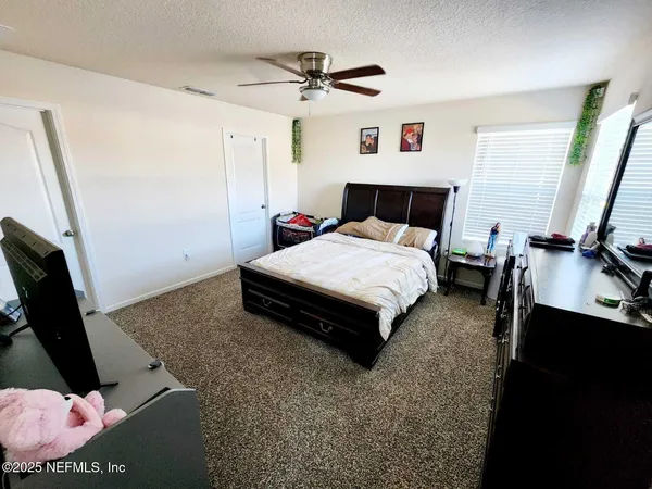 a bed room with a bed window and a television