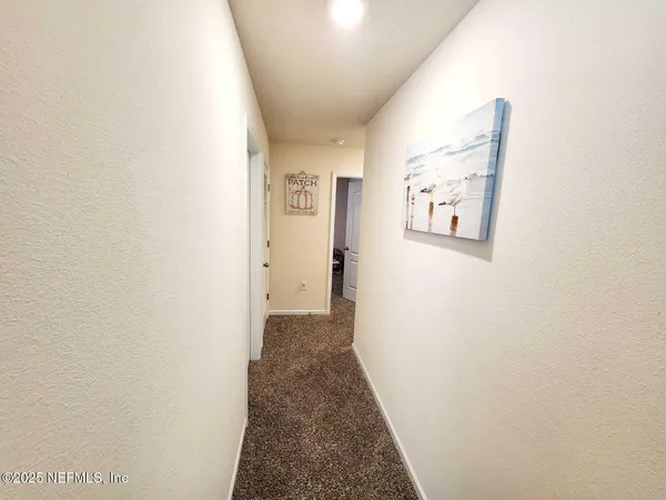 a view of a hallway with a white walls
