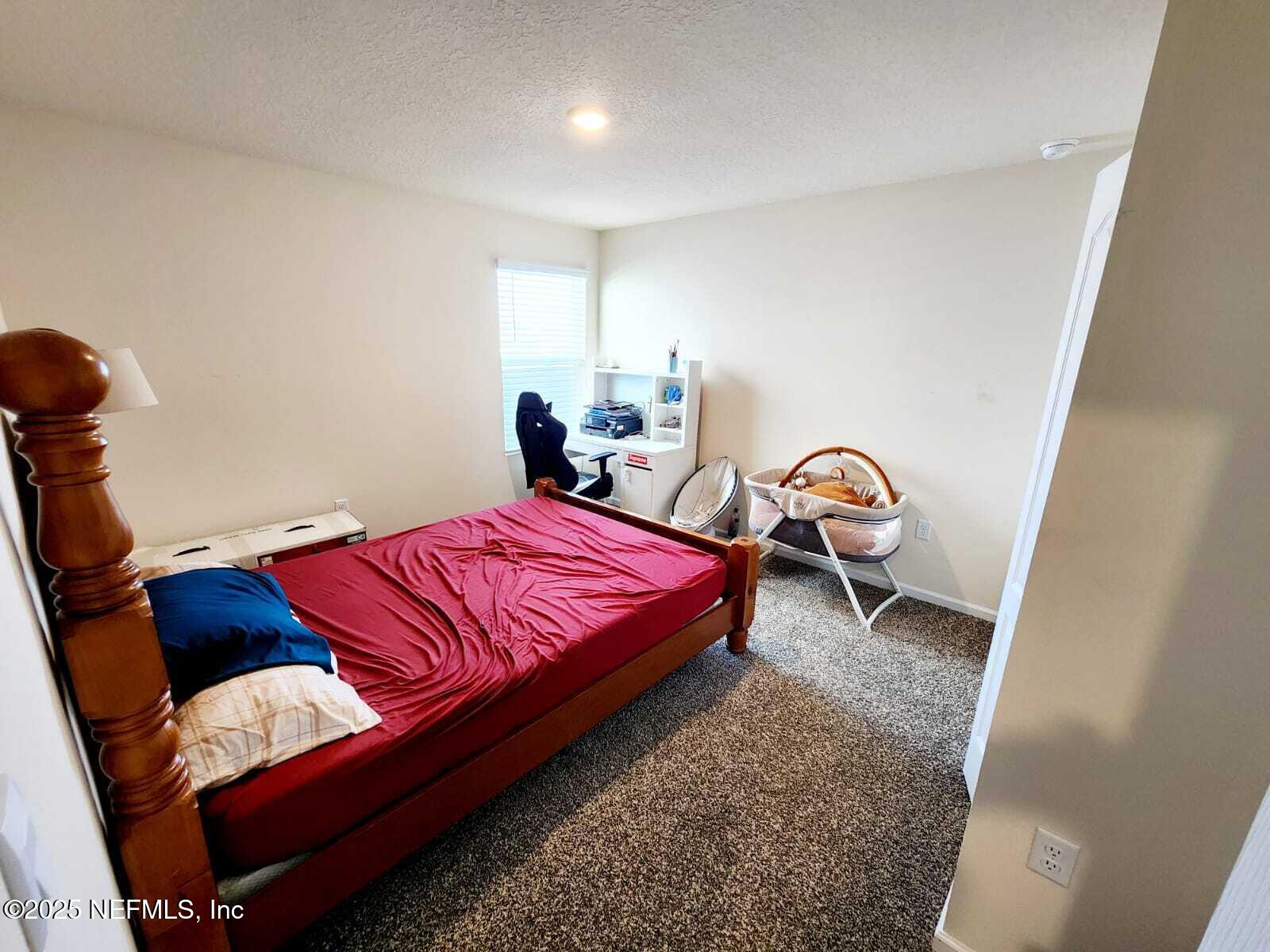 2432 Falling Star Ln Green Cove Springs Green Cove Springs, FL 32043 - Photo 9 of 24 a bedroom with a bed and a window