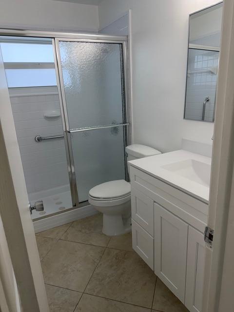3801 Northeast 22nd Terrace, Unit 12 Lighthouse Point, FL 33064 - Photo 13 of 14 a bathroom with a granite countertop sink toilet and shower