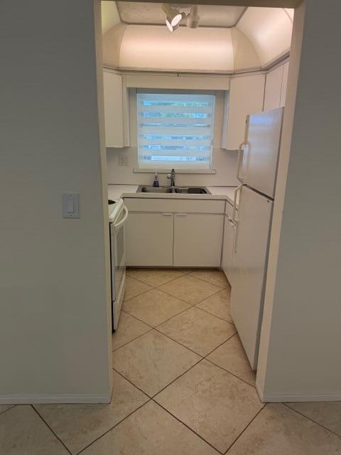 3801 Northeast 22nd Terrace, Unit 12 Lighthouse Point, FL 33064 - Photo 9 of 14 a utility room with cabinets