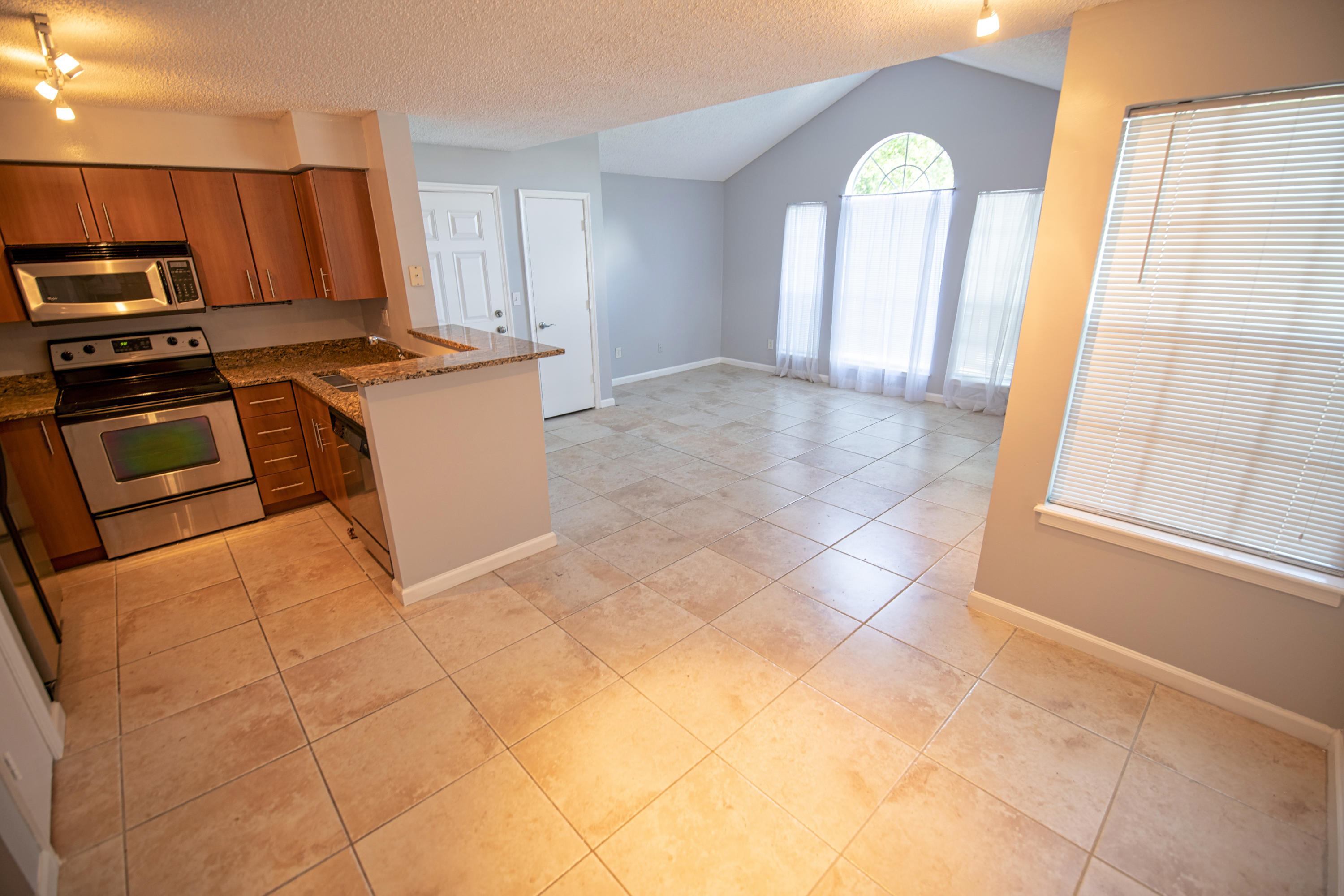 1165 Crystal Way, Unit B Delray Beach, FL 33444 - Photo 13 of 27 a view of a kitchen with furniture and stainless steel appliances