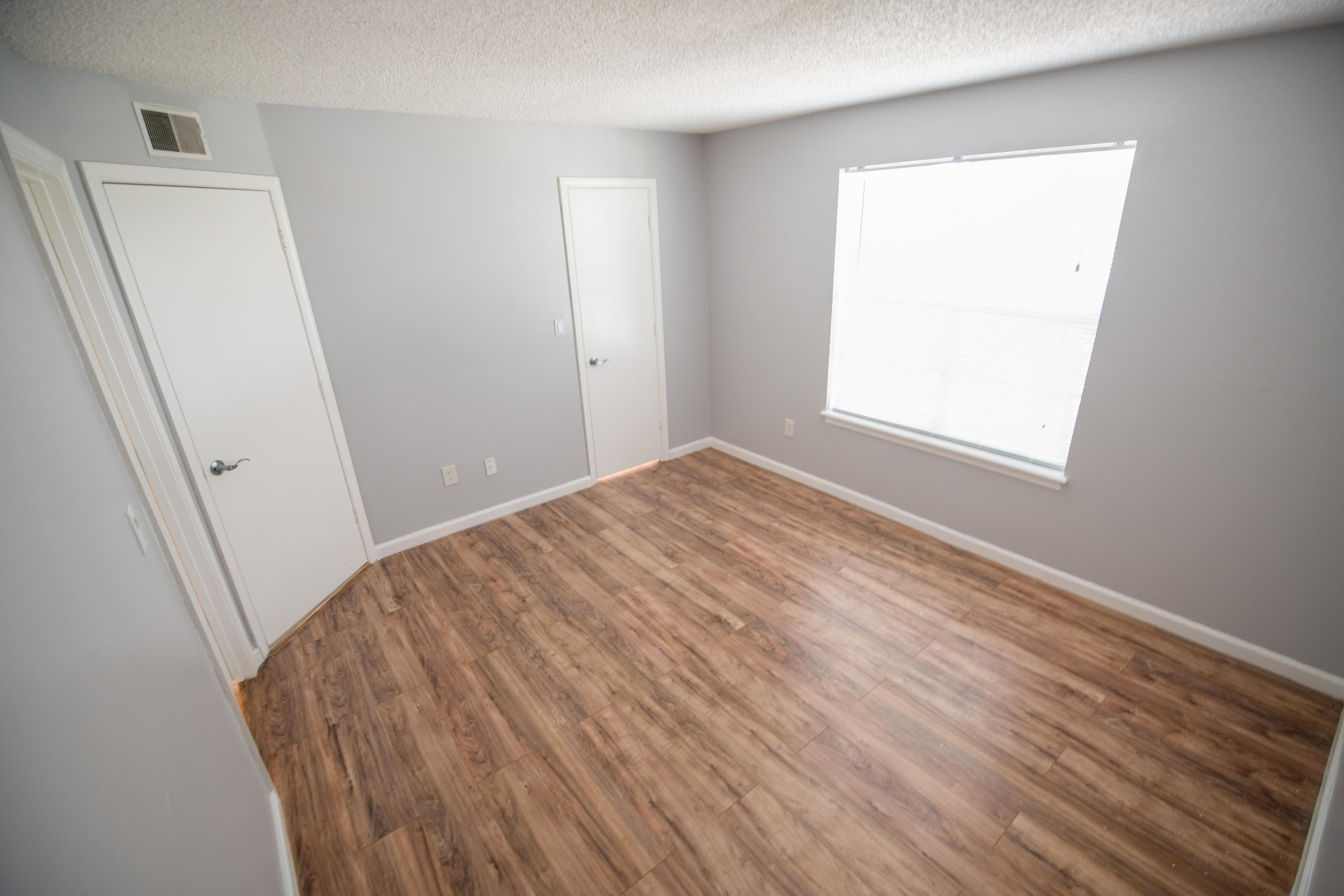1165 Crystal Way, Unit B Delray Beach, FL 33444 - Photo 15 of 27 a view of empty room with window and wooden floor