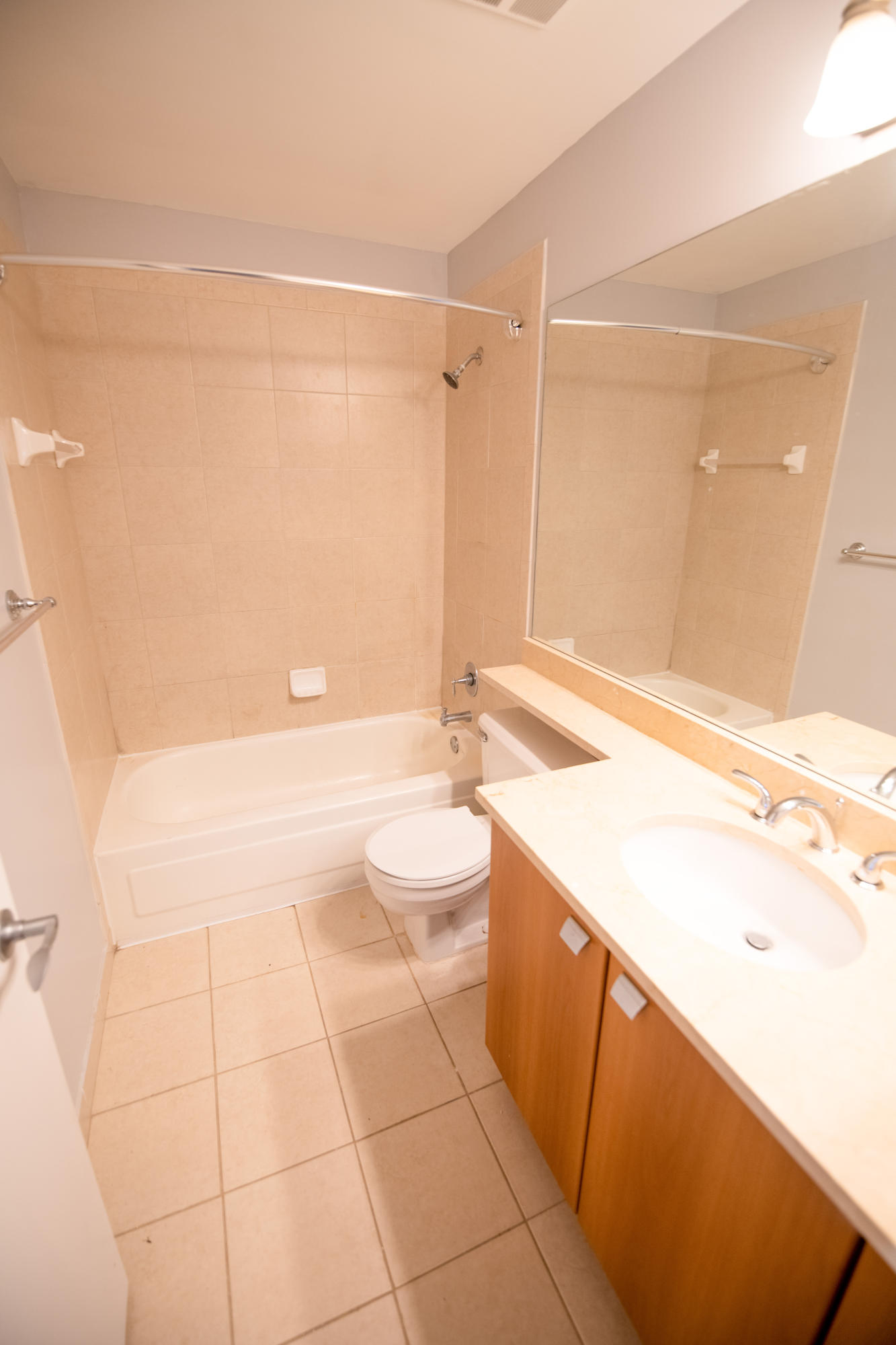 1165 Crystal Way, Unit B Delray Beach, FL 33444 - Photo 18 of 27 a bathroom with a granite countertop sink a toilet and shower