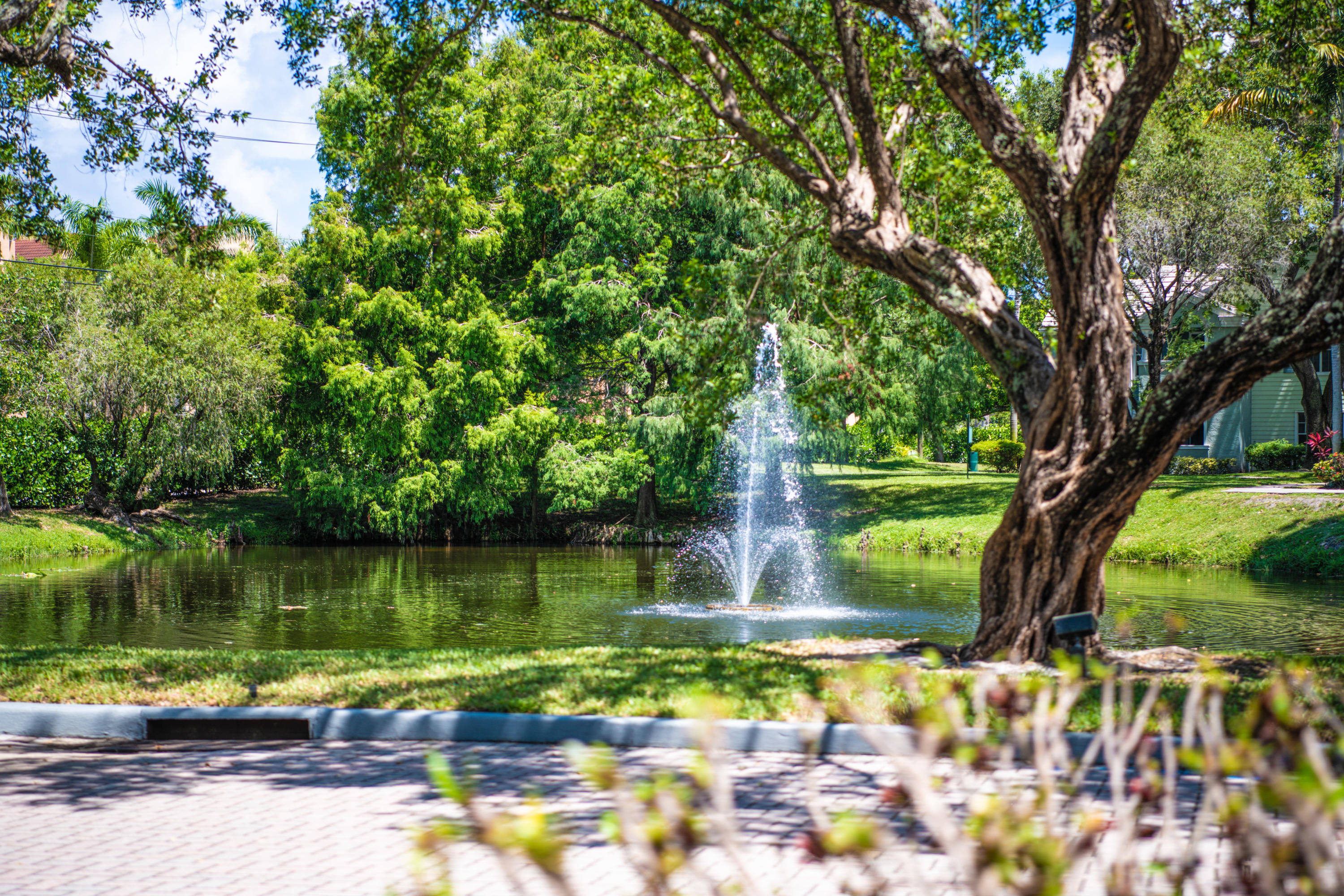 1165 Crystal Way, Unit B Delray Beach, FL 33444 - Photo 2 of 27 a view of a lake with a yard