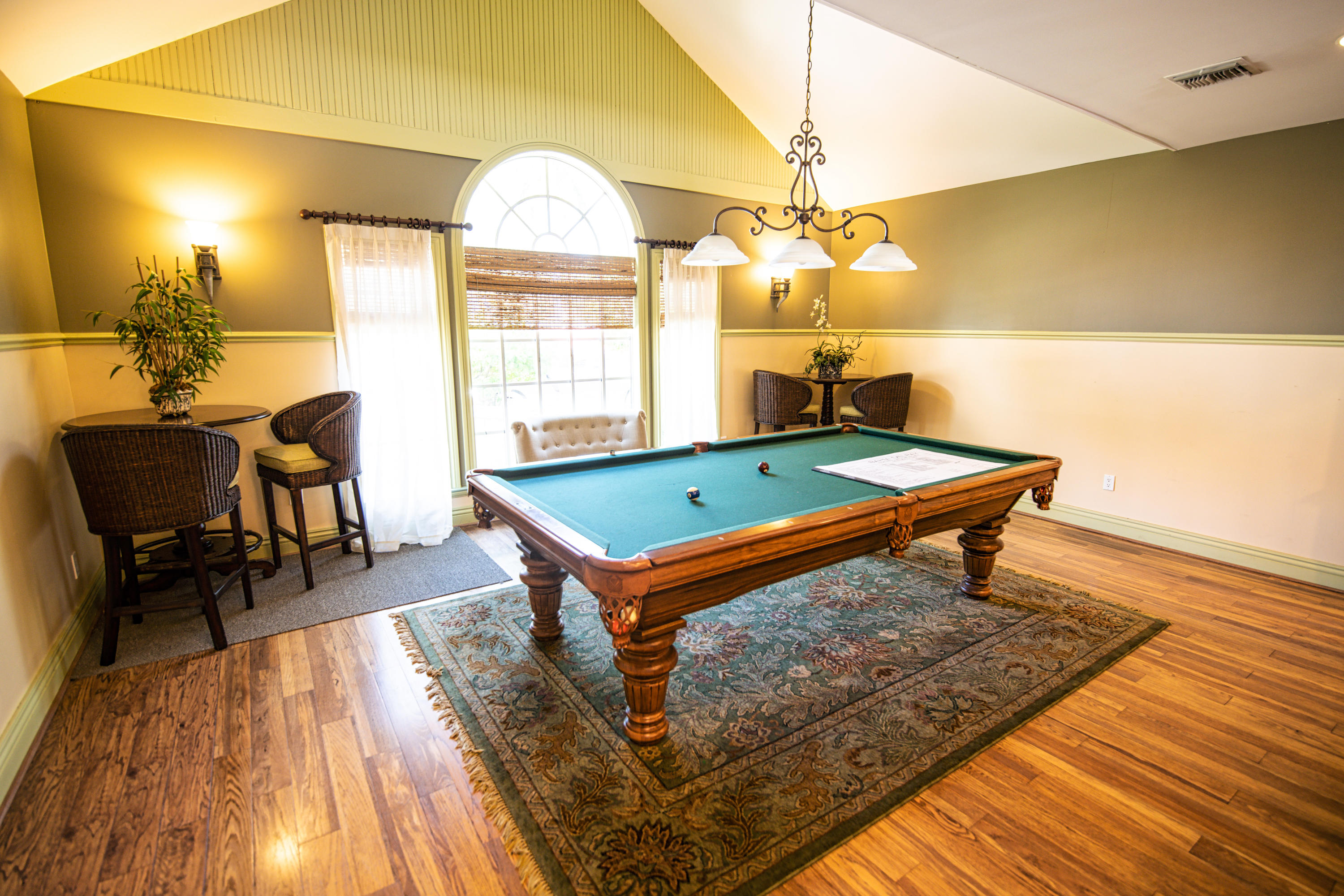 1165 Crystal Way, Unit B Delray Beach, FL 33444 - Photo 21 of 27 a room with wooden floor pool table and windows