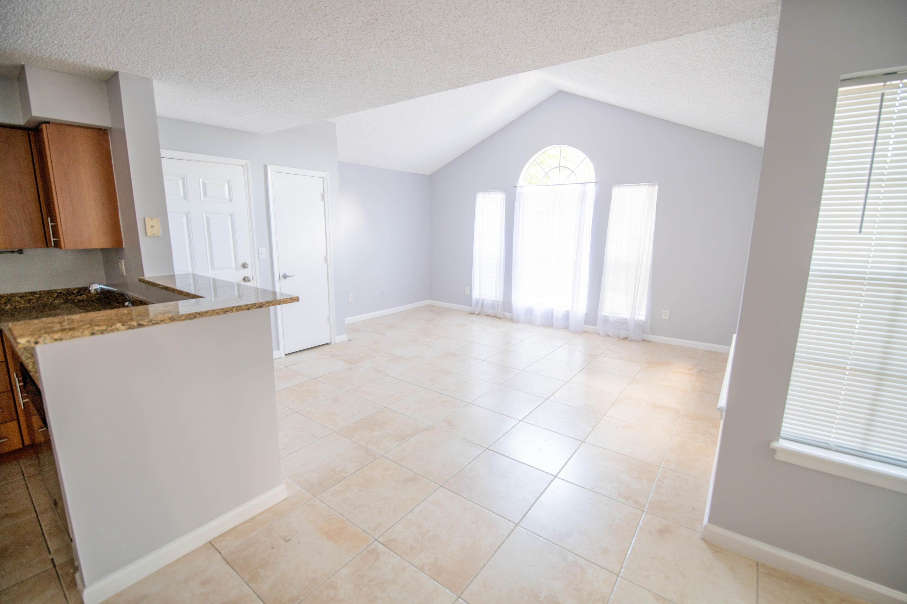 1165 Crystal Way, Unit B Delray Beach, FL 33444 - Photo 6 of 27 a view of a kitchen with wooden floor and a window