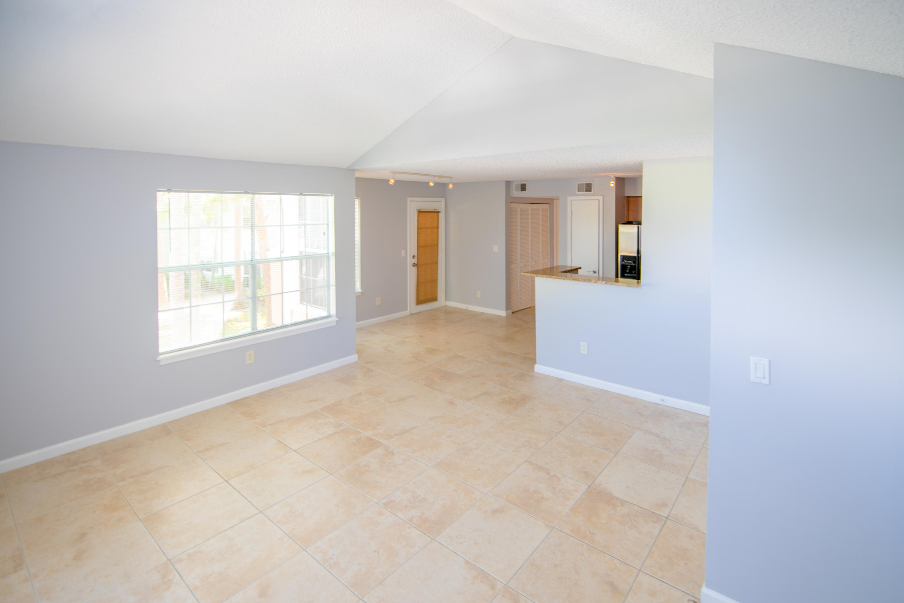 1165 Crystal Way, Unit B Delray Beach, FL 33444 - Photo 9 of 27 an empty room with windows