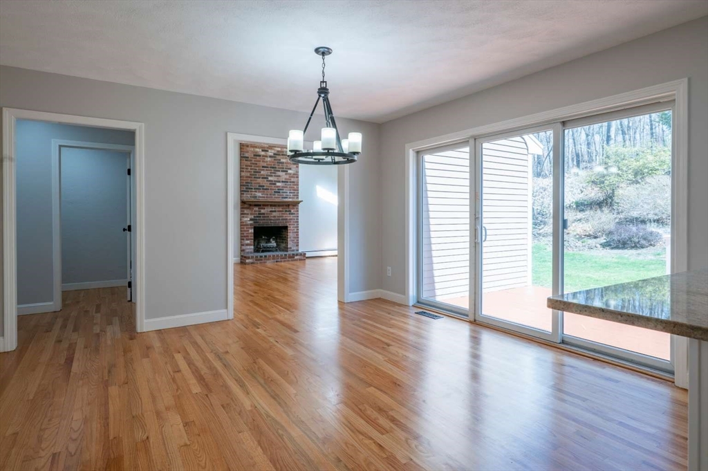 120 Bear Hill Road North Andover, MA 01845 - Photo 12 of 42 a view of a room with wooden floor fireplace and windows