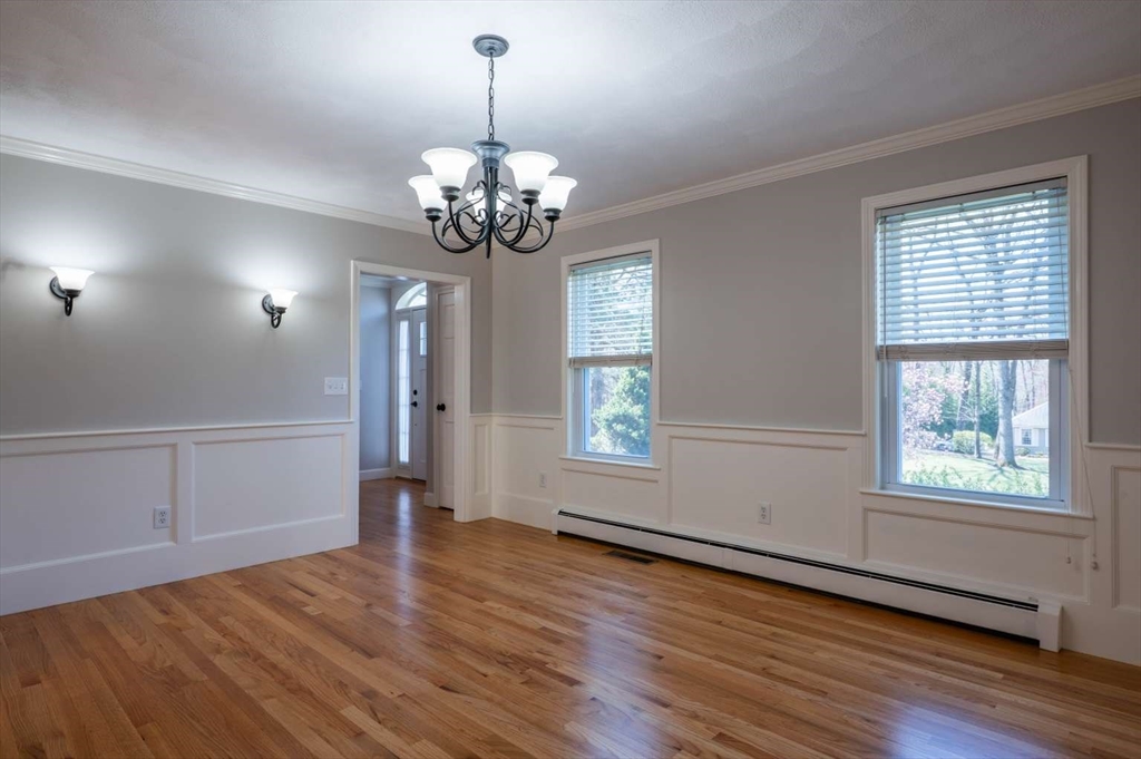 120 Bear Hill Road North Andover, MA 01845 - Photo 13 of 42 a view of a livingroom with a chandelier wooden floor and windows