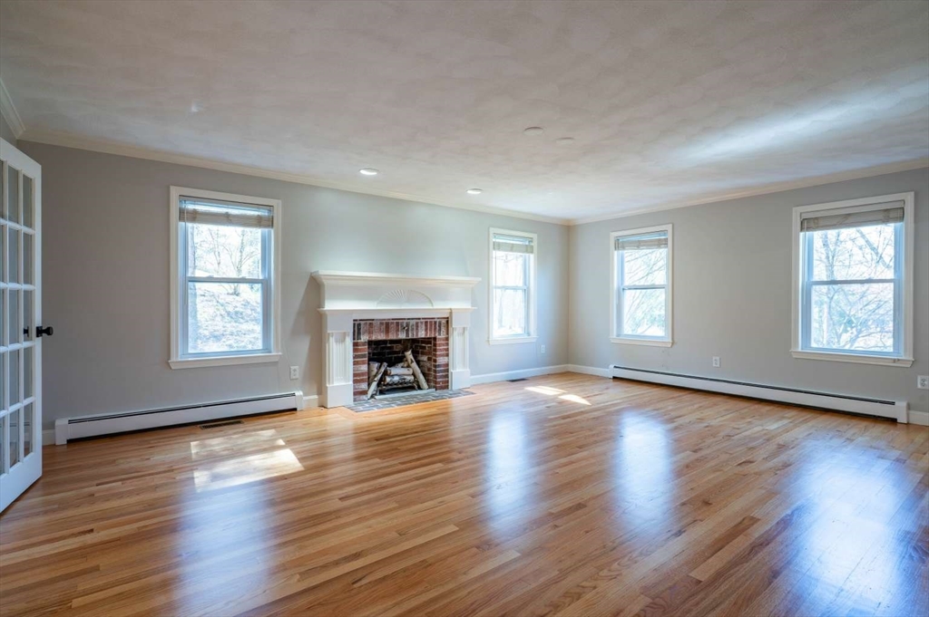120 Bear Hill Road North Andover, MA 01845 - Photo 14 of 42 an empty room with wooden floor fireplace and windows