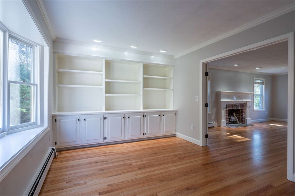 120 Bear Hill Road North Andover, MA 01845 - Photo 16 of 42 an empty room with wooden floor fireplace and windows