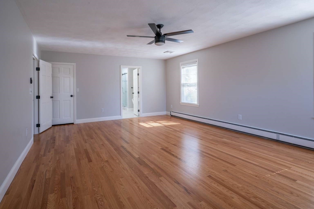 120 Bear Hill Road North Andover, MA 01845 - Photo 21 of 42 wooden floor in an empty room with a window