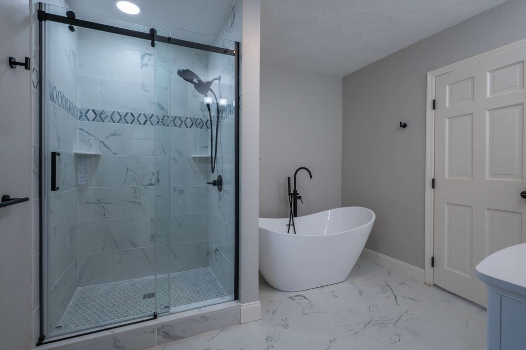 120 Bear Hill Road North Andover, MA 01845 - Photo 23 of 42 a bathroom with a bathtub and shower