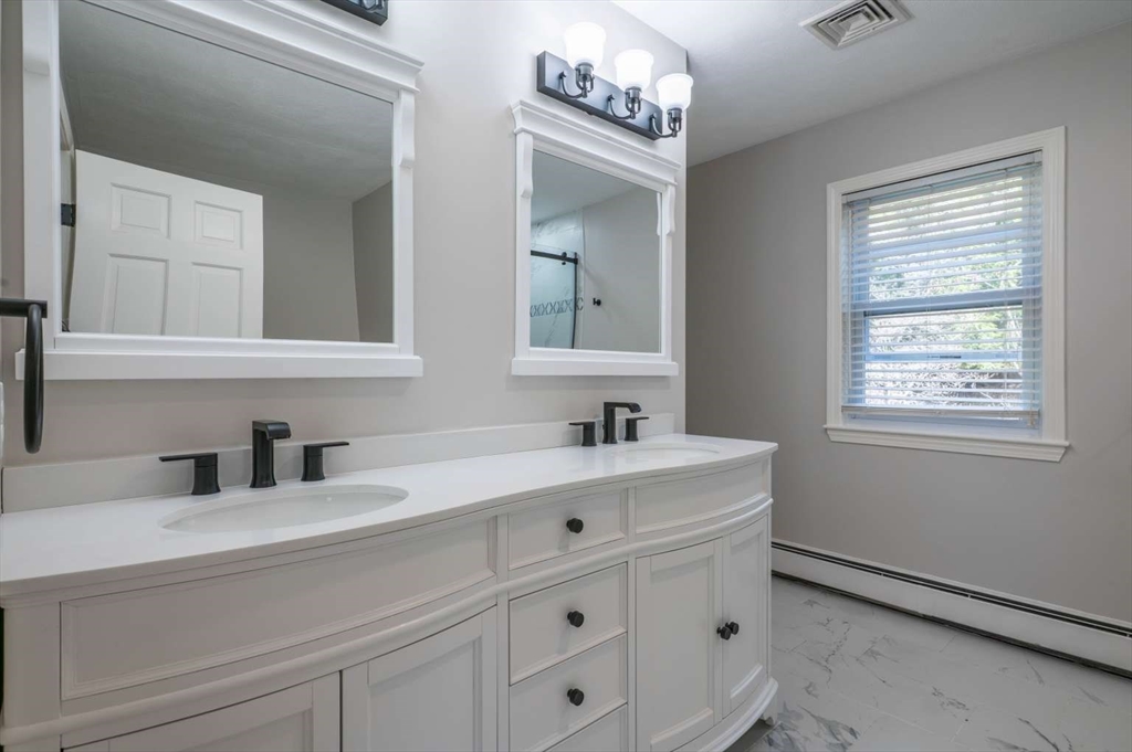 120 Bear Hill Road North Andover, MA 01845 - Photo 24 of 42 a bathroom with a sink vanity and mirror