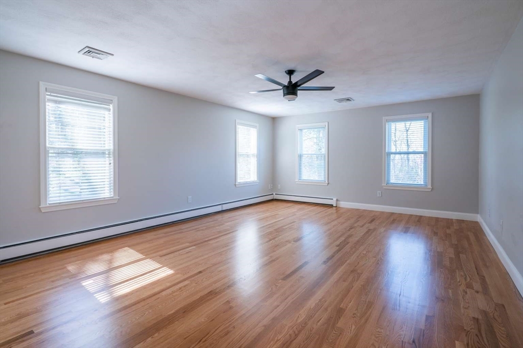 120 Bear Hill Road North Andover, MA 01845 - Photo 25 of 42 a view of an empty room with wooden floor and a window