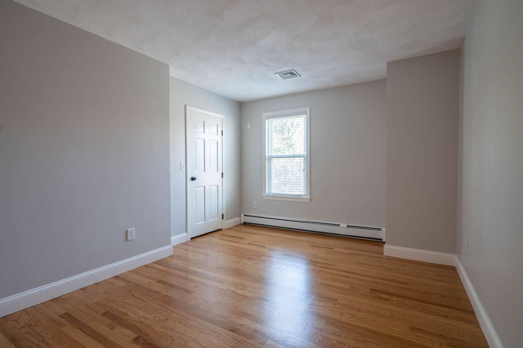 120 Bear Hill Road North Andover, MA 01845 - Photo 26 of 42 a view of an empty room with wooden floor and a window