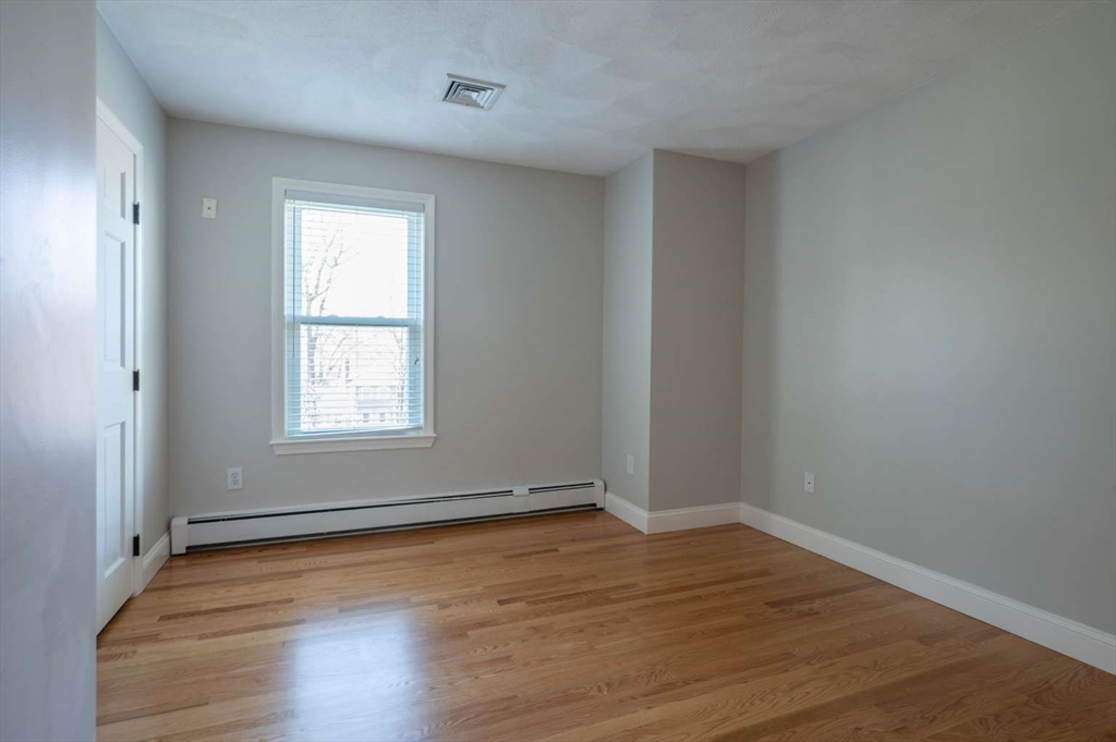 120 Bear Hill Road North Andover, MA 01845 - Photo 27 of 42 an empty room with wooden floor and windows