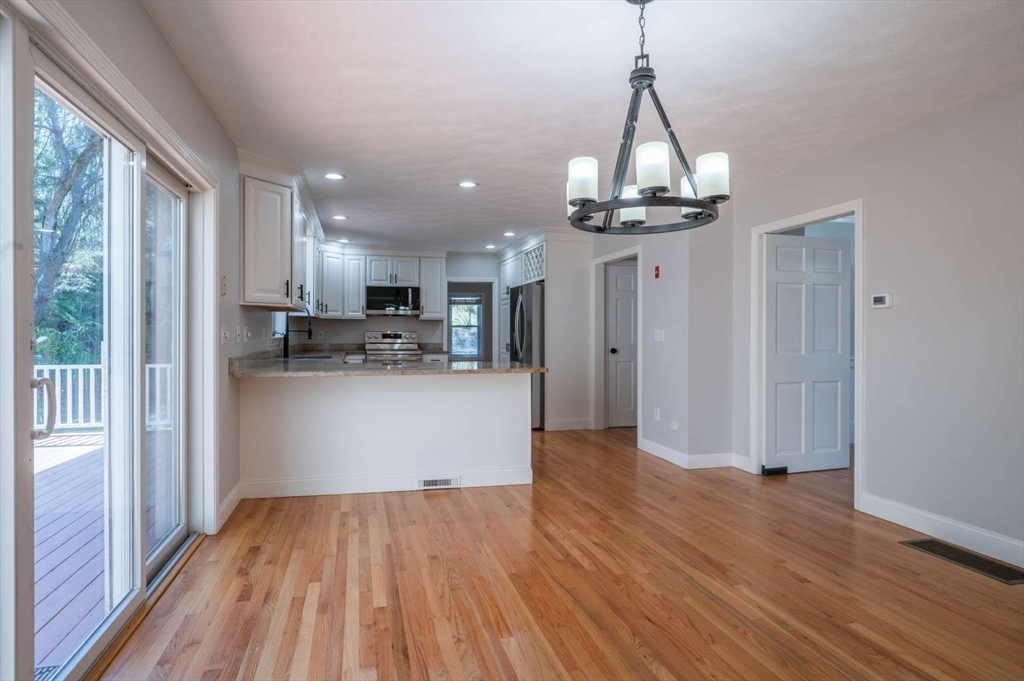 120 Bear Hill Road North Andover, MA 01845 - Photo 6 of 42 a view of a kitchen with wooden floor and a window