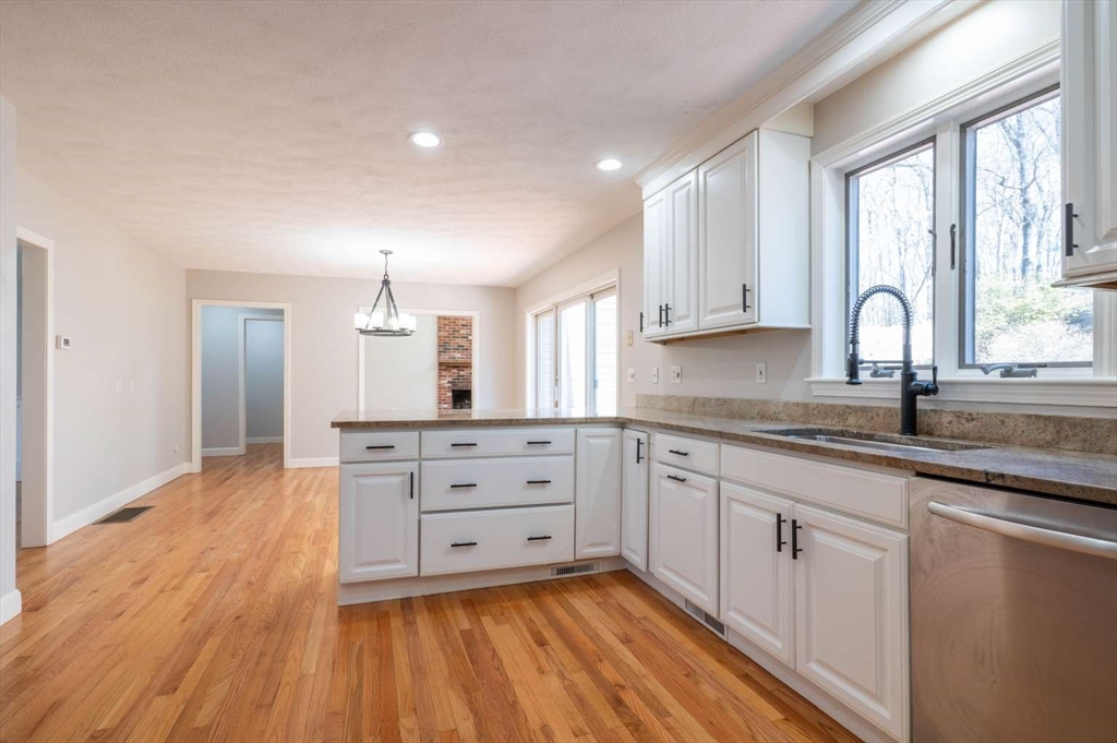 120 Bear Hill Road North Andover, MA 01845 - Photo 9 of 42 a kitchen with granite countertop white cabinets and white appliances
